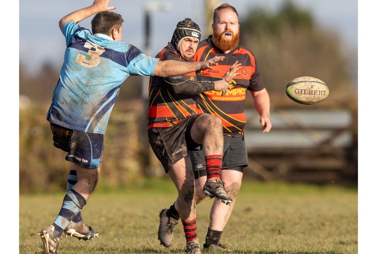 James Noel-Johnson kicks the ball through under pressure from Bodmin prop Mark Adams. Picture: Nigel Yeo