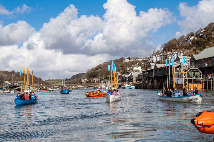 The flotilla of craft stopped by the fish market and raised their oars as a salute to the intrepid crew of Oars of Thunder. (Picture: RNLI Looe)